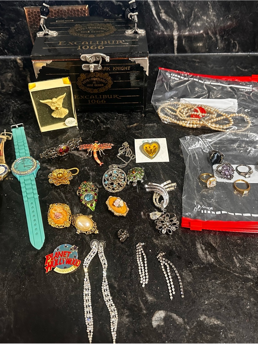 Assorted Vintage and Current brochures, rings, watches and earrings.